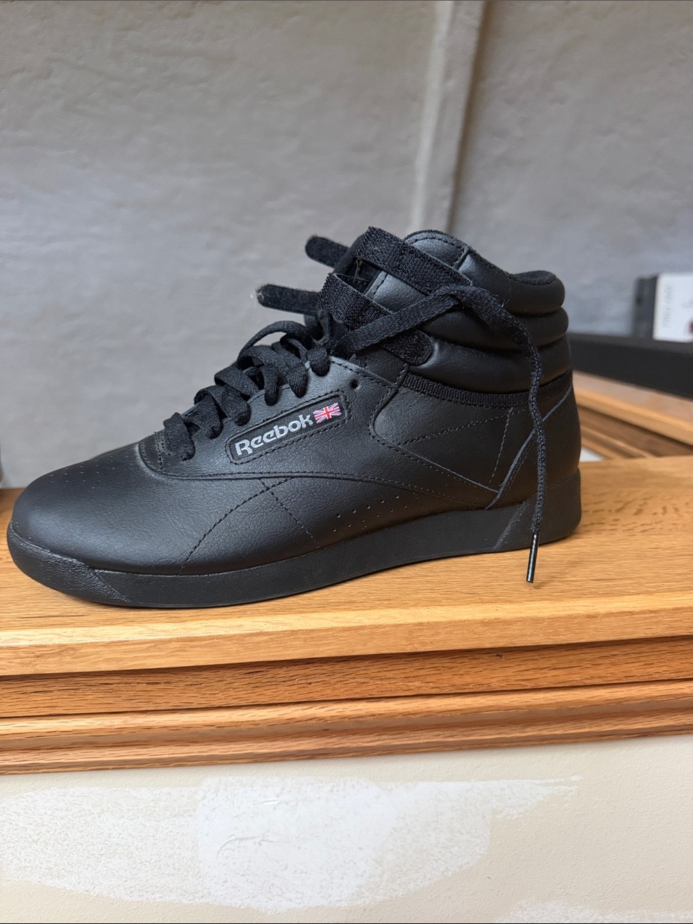 Reebok Black High-Top Leather Sneaker with Small Flag Accent